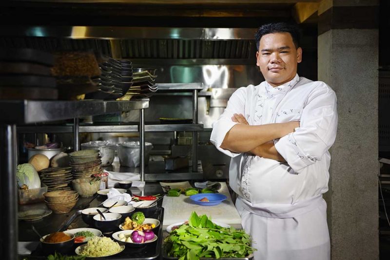 THRU Works Program to match San Antonio companies with former foster care youth workers portrait of adult man at work as chef in the kitchen of an asian restaurant posing with arms crossed