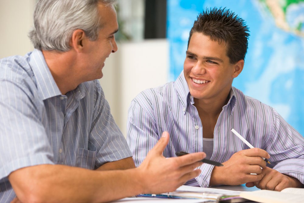 an older man mentors a younger man