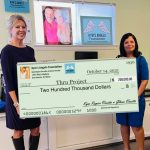 Yolanda presenting Elaine with check